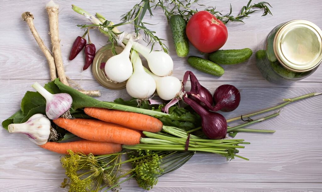 Closeup of freshly harvested vegetables (onion, garlic, red paper, dill, cucumber, carrots, round marrow